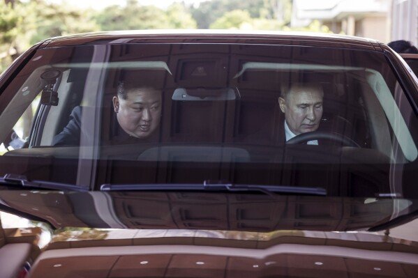 Russian President Vladimir Putin, right, and North Korea's leader Kim Jong Un drive a Russian Aurus limousine during their meeting in Pyongyang, North Korea, on June 19, 2024. (Gavriil Grigorov, Sputnik, Kremlin Pool Photo via AP)