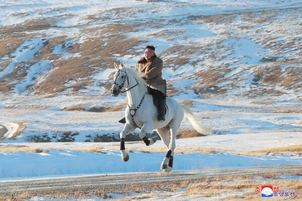 FILE - In this photo provided on Oct. 16, 2019, by the North Korean government, North Korean leader Kim Jong Un rides a white horse to climb Mount Paektu, North Korea. Russia recently sent North Korean leader Kim Jong Un a trainload of 30 thoroughbred horses, opening the border with its neighbor for the first time in 2 1/2 years. The content of this image is as provided and cannot be independently verified. Korean language watermark on image as provided by source reads: 