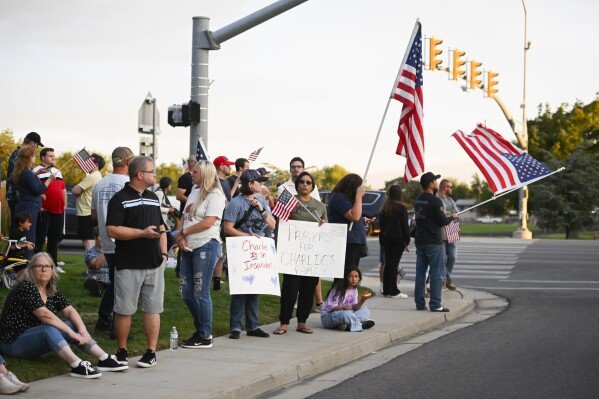 People outside at Timpanogos Regional Hospital await the transport of Charlie Kirk, the CEO and co-founder of Turning Point USA who was shot and killed, on Wednesday, Sept. 10, 2025, in Orem, Utah. (AP Photo/Alex Goodlett)