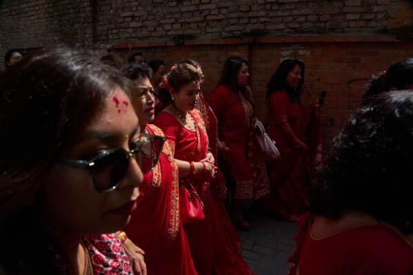 Devotees follow newly appointed living goddess Kumari Aryatara Shakya as she is carried toward Kumari Ghar, the temple palace where she will be residing in Kathmandu, Nepal, Tuesday, Sept. 30, 2025. (AP Photo/Niranjan Shrestha)