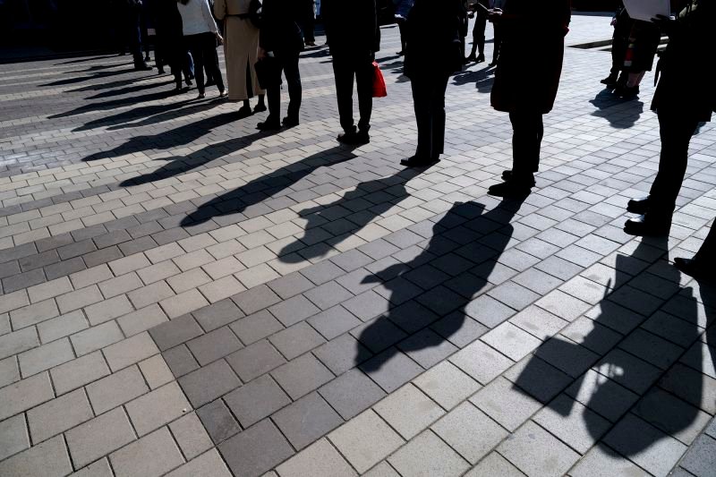 Job seekers wait in line to enter a job fair event in Silver Spring, Maryland, on April 16.