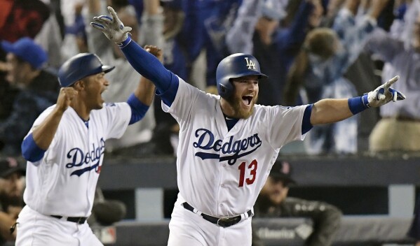 FILE - In this Oct. 27, 2018, file photo, Los Angeles Dodgers' Max Muncy, right, celebrates after hitting the game-winning home run in the 18th inning against the Boston Red Sox in Game 3 of the World Series in Los Angeles. (AP Photo/Mark J. Terrill, File)