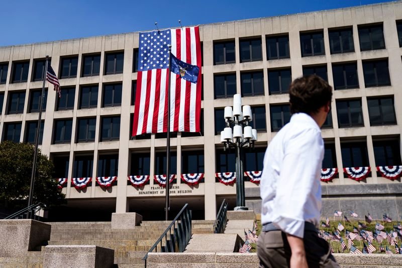 A member of the public passes the US Department of Labor in Washington DC, on September 5.