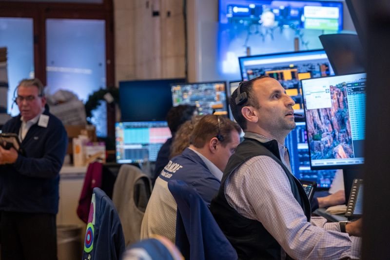 Traders work on the floor of the New York Stock Exchange on October 20, 2025.