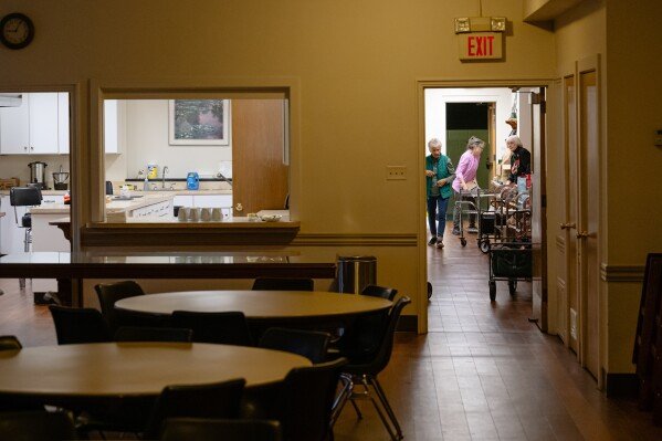 Volunteers prepare packaged meals ahead of the food pantry service at Calvary Episcopal Church on Thursday, Oct. 30, 2025, in Louisville, Ky. (AP Photo/Jon Cherry)