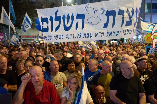 People attend a rally in Tel Aviv, Israel, on Saturday, Nov. 1, 2025, marking 30 years since the assassination of Prime Minister Yitzhak Rabin. (AP Photo/Ariel Schalit)