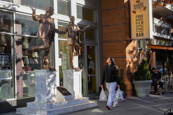 Protest art representing President Donald Trump and Jeffrey Epstein is seen outside the entrance to Busboys and Poets restaurant in the U Street neighborhood of Washington, Thursday, Nov., 13, 2025. (AP Photo/Pablo Martinez Monsivais)