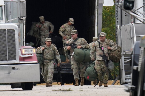 Military personnel in uniform, with the Texas National Guard patch on, are seen at the U.S. Army Reserve Center, Oct. 7, 2025, in Elwood, Ill., a suburb of Chicago. (AP Photo/Erin Hooley, File)