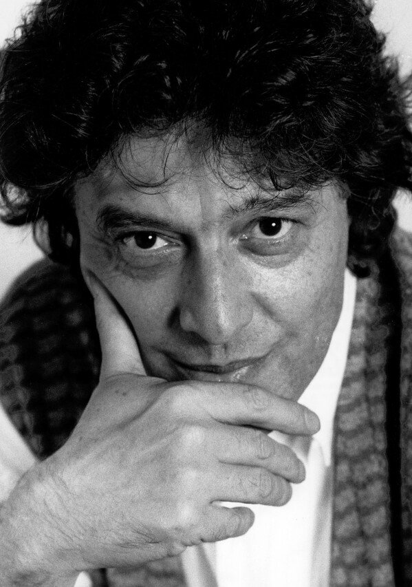 Tom Stoppard poses for a portrait with his face in his hands during an interview in New York, 1989. (AP Photo/Marty Reichenthal)