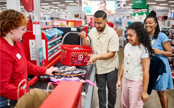 A Target team member assists a family at checkout.