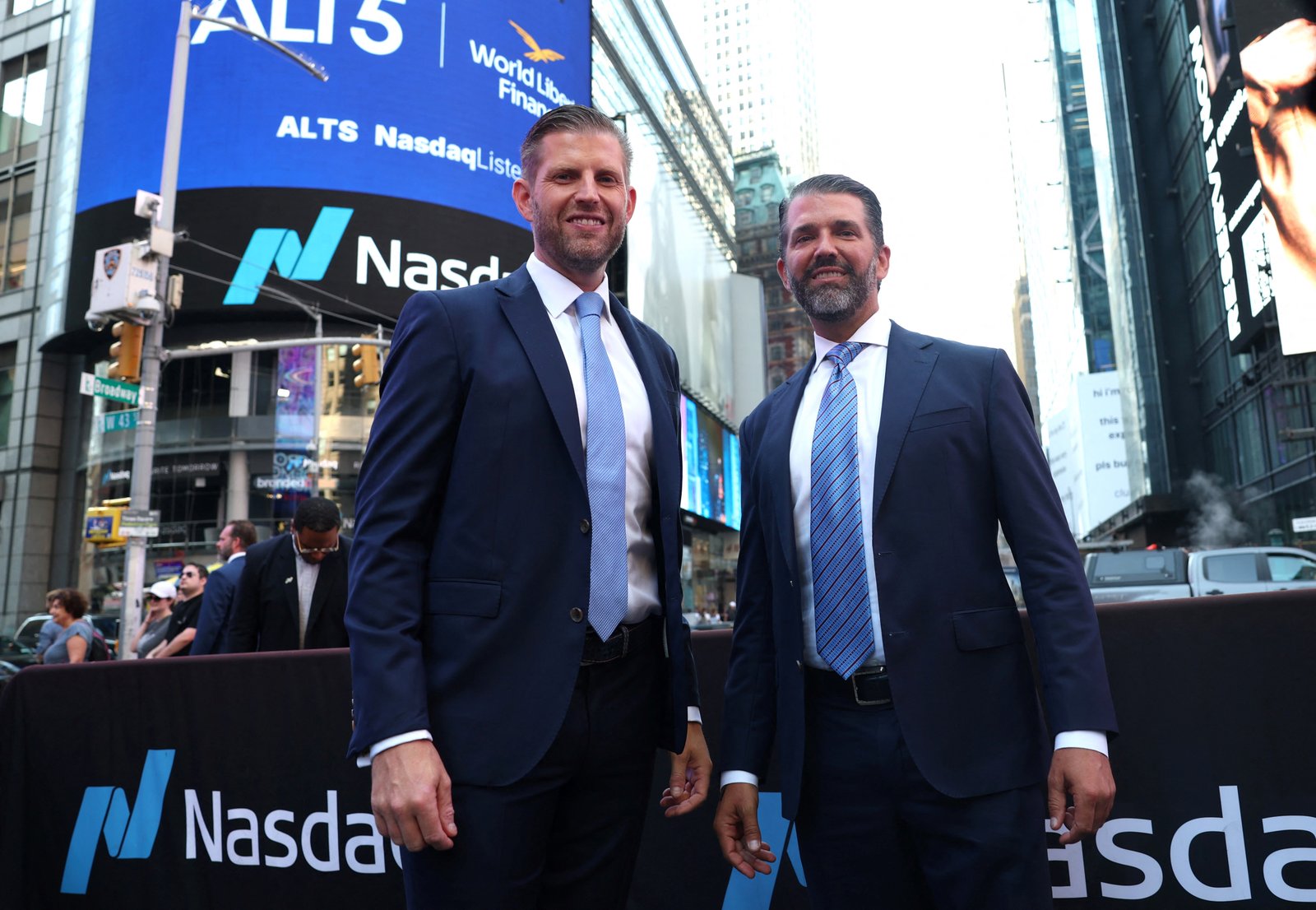 Eric Trump and Donald Trump Jr. pose outside Nasdaq in Times Square.