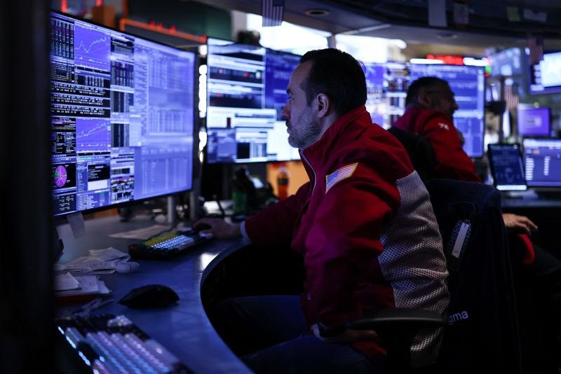Traders work on the floor of the New York Stock Exchange on December 1.