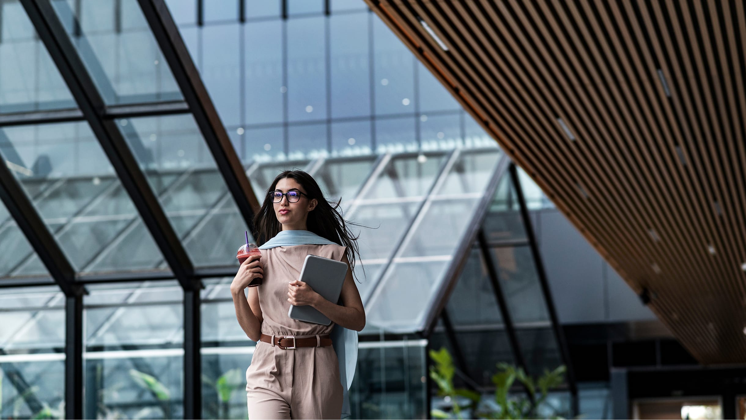 woman walking outside with laptop