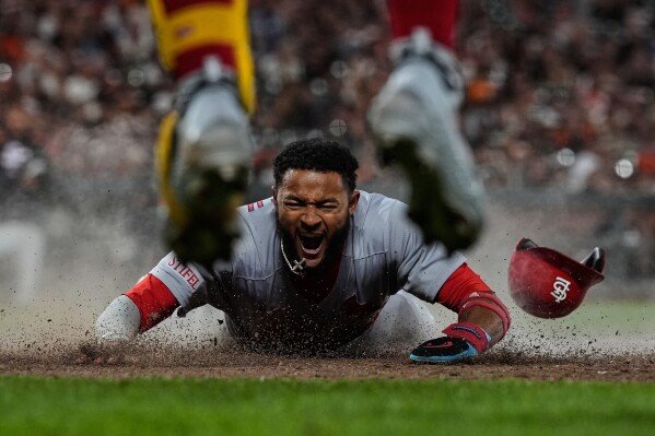 St. Louis Cardinals' Victor Scott II scores against the San Francisco Giants during a baseball game in San Francisco on Sept. 23, 2025. (AP Photo/Godofredo A. Vásquez)