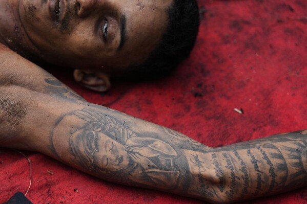 The body of a man killed during a police raid targeting the Comando Vermelho gang, lies in the Complexo da Penha favela of Rio de Janeiro, Brazil, Oct. 29, 2025. (AP Photo/Silvia Izquierdo)