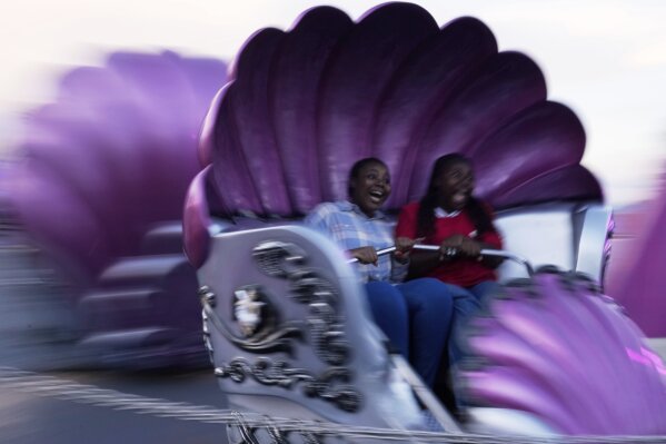 Girls scream while they ride the Tempest at the Rand Show in Johannesburg, South Africa, April 19, 2025. (AP Photo/Themba Hadebe)