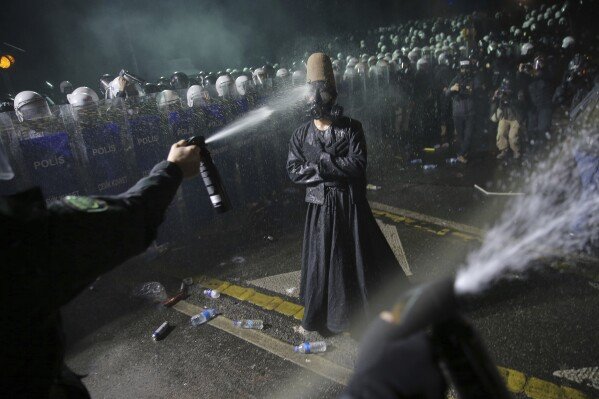 Riot police use pepper spray against a protester after Istanbul's Mayor Ekrem Imamoglu was arrested and sent to prison in Istanbul on March 23, 2025. (AP Photo/Huseyin Aldemir)