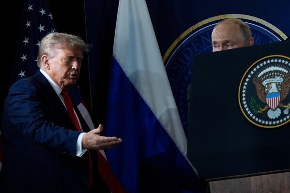 U.S. President Donald Trump and Russian President Vladimir Putin arrive for a press conference at Joint Base Elmendorf- Richardson in Anchorage, Alaska, on Aug. 15, 2025. (AP Photo/Julia Demaree Nikhinson)