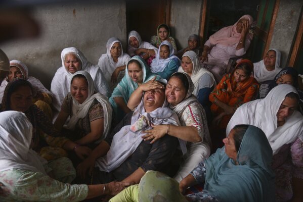 Jabir Kaur, center, who’s husband, Sukhwinder Singh, died after consuming toxic liquor, mourns on May 13, 2025, in Majitha, India. (AP Photo/Prabhjot Gill)