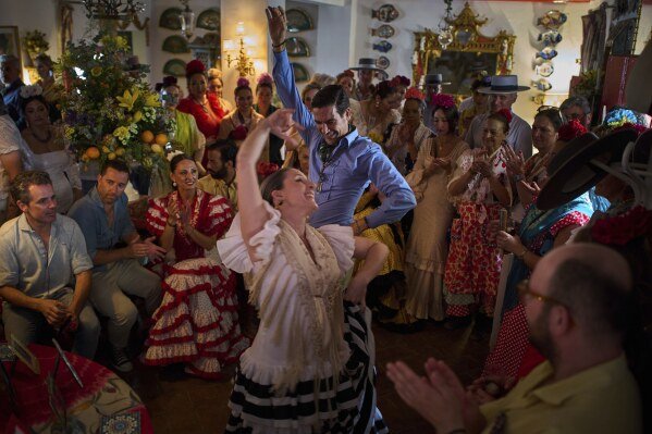 Pilgrims dance the Sevillanas on June 8, 2025, during the annual Catholic pilgrimage to the shrine of the Virgin of El Rocio that draws hundreds of thousands of faithful in El Rocio, Spain. (AP Photo/Emilio Morenatti)