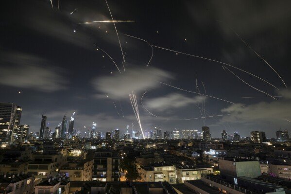The Israeli Iron Dome air defense system intercepts missiles during an Iranian attack on Tel Aviv, Israel, June 18, 2025. (AP Photo/Leo Correa)
