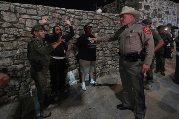 People protesting immigration enforcement are detained by Texas state troopers near the Alamo in downtown San Antonio on June 11, 2025. (AP Photo/Eric Gay)