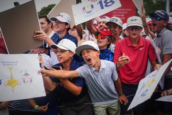 Fans try to get autographs during a practice round for the Ryder Cup golf tournament at the Bethpage Black golf course, in Farmingdale, N.Y., on Sept. 24, 2025. (AP Photo/Lindsey Wasson)