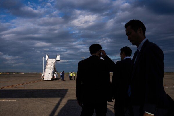 Security personnel take position just before the arrival of President Donald Trump on Air Force One at Haneda International Airport in Tokyo on Oct. 27, 2025. (AP Photo/Louise Delmotte)