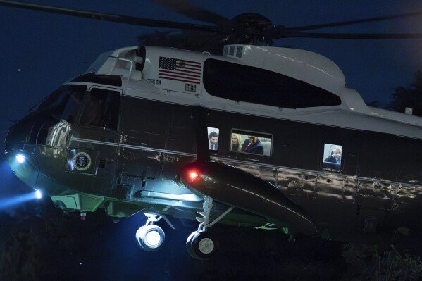 President Donald Trump looks through the window of Marine One upon his arrival at the White House in Washington on Sept. 18, 2025. (AP Photo/Jose Luis Magana)