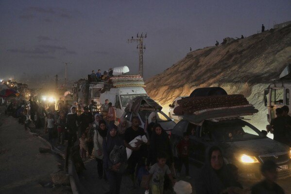 Displaced Palestinians flee Gaza City with their belongings along the coastal road in Nuseirat, toward the southern Gaza Strip, on Sept. 19, 2025. (AP Photo/Abdel Kareem Hana)
