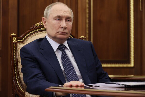 Russian President Vladimir Putin listens to director of the Federal Penitentiary Service Arkady Gostev at the Kremlin in Moscow, Monday, Dec. 1, 2025. (Gavriil Grigorov/Sputnik, Kremlin Pool Photo via AP)