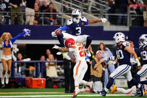 Dallas Cowboys wide receiver George Pickens (3) leaps over Kansas City Chiefs cornerback Trent McDuffie (22) during the second half of an NFL football game Thursday, Nov. 27, 2025, in Arlington, Texas. (AP Photo/Tony Gutierrez)