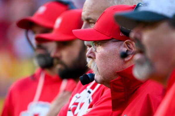 Kansas City Chiefs head coach Andy Reid, wearing headset, watches with other coaches from the sidelines during overtime in an NFL football game against the Indianapolis Colts, Sunday, Nov. 23, 2025 in Kansas City, Mo. (AP Photo/Reed Hoffmann)