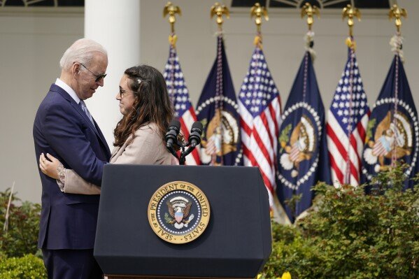President Joe Biden hugs Mia Tretta, a survivor of the Saugus Hight School shooting in Santa Clarita, Calif., after she spoke in the Rose Garden of the White House in Washington, April 11, 2022. Biden announced a final version of the administration's ghost gun rule, which comes with the White House and the Justice Department under growing pressure to crack down on gun deaths. (AP Photo/Carolyn Kaster, File)