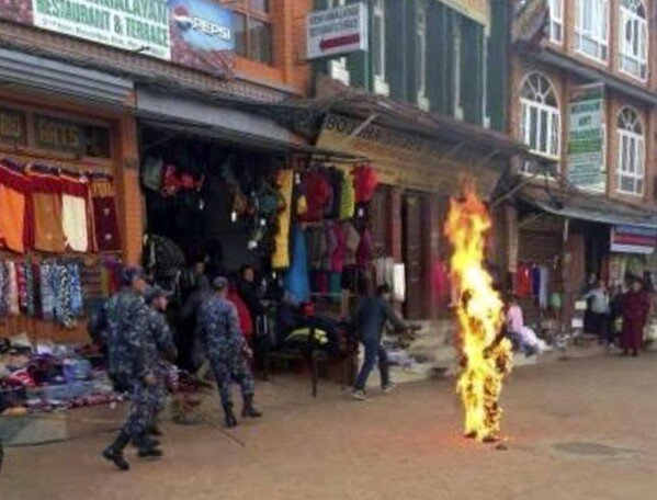 Nepalese policemen rush as a Tibetan monk burns after he set himself on fire in Katmandu, Nepal, Wednesday, Feb. 13, 2013. The Tibetan monk doused himself with gasoline and set himself on fire in Nepal's capital Wednesday in what is believed to be the latest self-immolation to protest Chinese rule in Tibet. ( AP Photo)