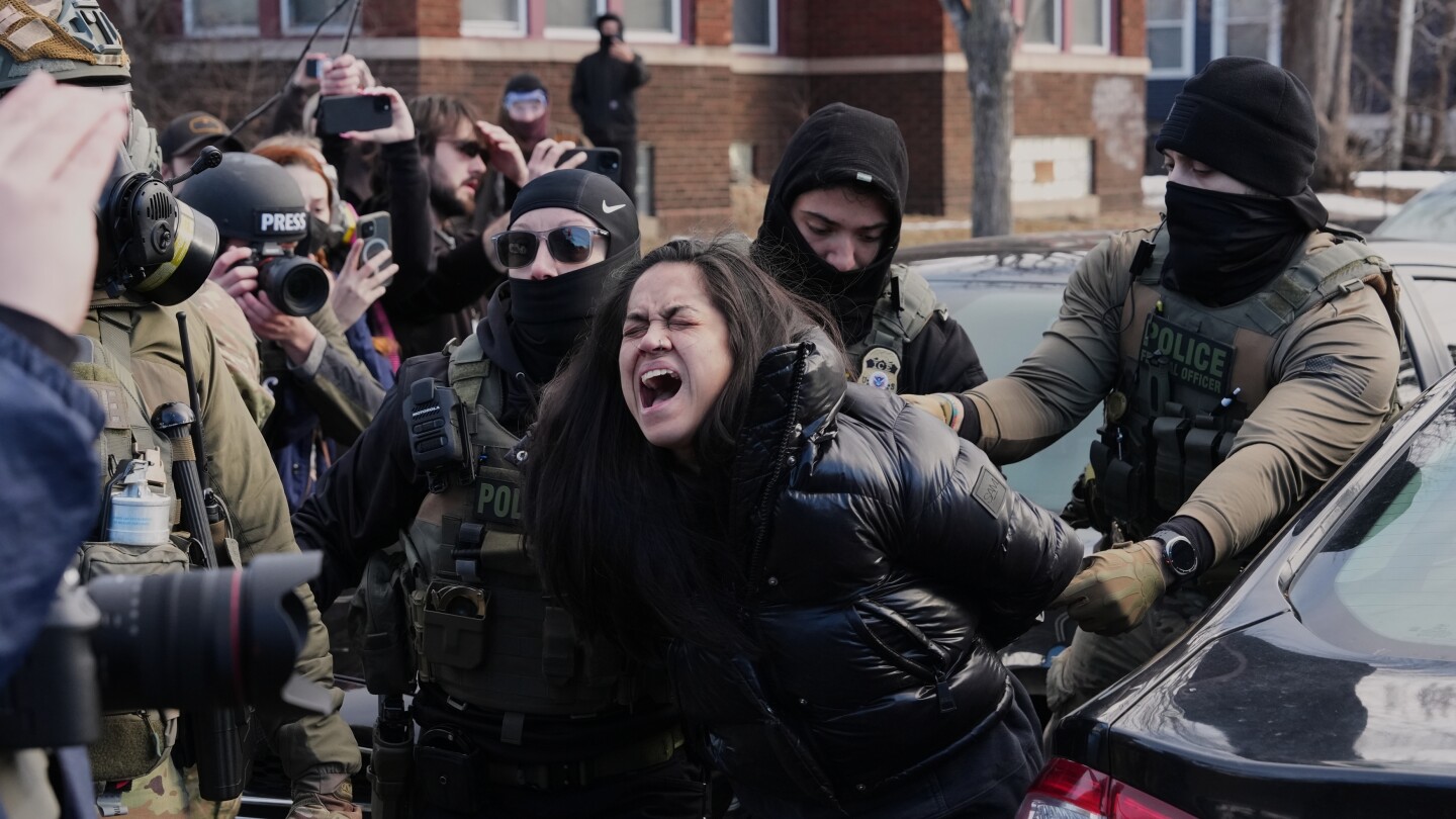 federal-immigration-agents-filmed-dragging-a-woman-from-her-car-in-minneapolis