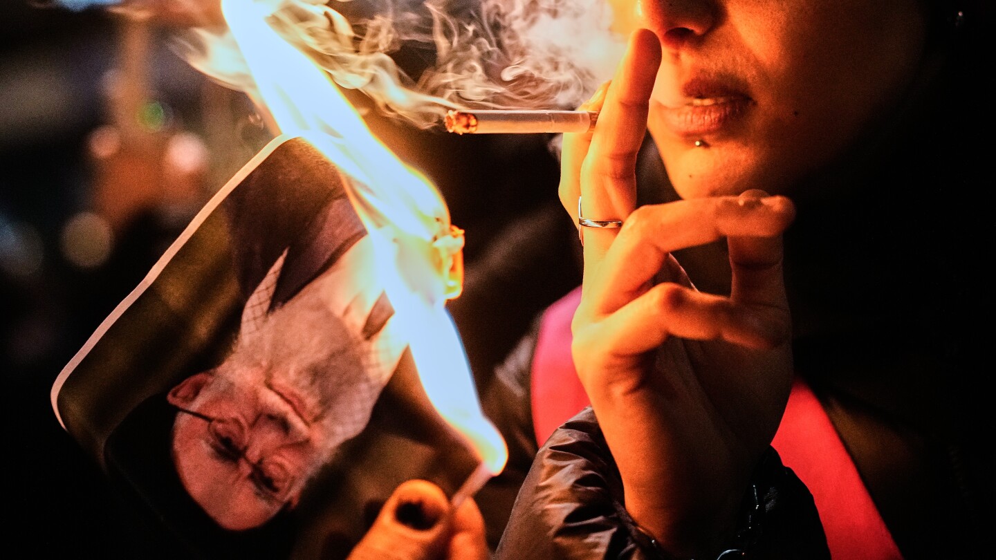 she-lit-a-cigarette,-set-a-photo-afire-—-and-became-a-symbol-of-resistance-for-iran-protesters