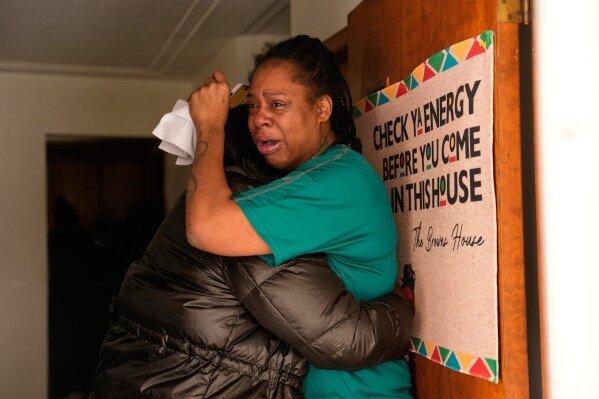 A family member reacts after federal immigration officers make an arrest Sunday, Jan. 11, 2026, in Minneapolis. (AP Photo/John Locher)