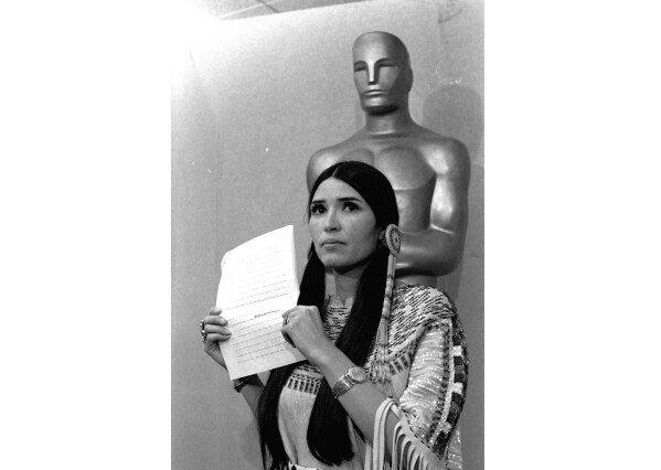 FILE - Sacheen Littlefeather appears at the Academy Awards ceremony to announce that Marlon Brando was declining his Oscar as best actor for his role in 