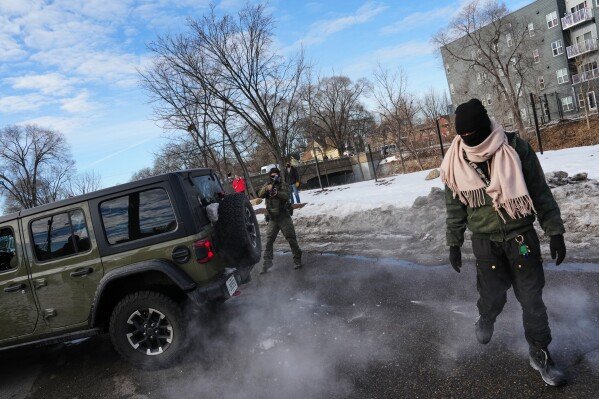 Federal immigration officers deploy pepper balls at a protester Monday, Jan. 12, 2026, in Minneapolis. (AP Photo/Adam Gray)