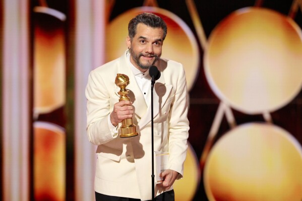 This image released by CBS Broadcasting shows Wagner Moura accepting the award for best lead actor in a motion picture drama for 
