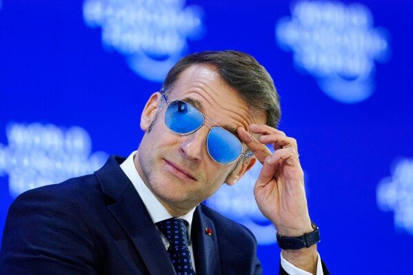 French President Emmanuel Macron touches his brow during the Annual Meeting of the World Economic Forum in Davos, Switzerland, Tuesday, Jan. 20, 2026. (AP Photo/Markus Schreiber)
