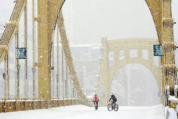People ride bikes over the Rachel Carson Bridge in downtown Pittsburgh, Sunday, Jan. 25, 2026. (AP Photo/Gene J. Puskar)