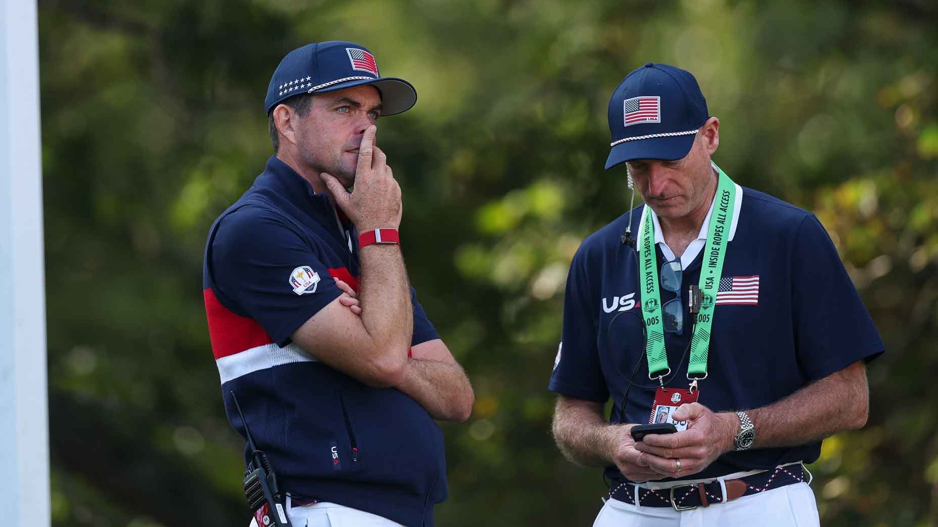 Captain Keegan Bradley of Team United States and vice captain Jim Furyk look on from the eighth hole during the Saturday morning foursomes matches of the 2025 Ryder Cup at Black Course at Bethpage State Park Golf Course on September 27, 2025 in Farmingdale, New York.