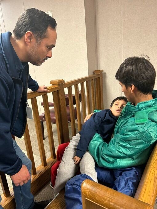 In this image provided by U.S. Rep. Joaquin Castro, Castro, left, visits with 5-year-old Liam Conejo Ramos and his father, Adrian Alexander Conejo Arias, at the South Texas Family Residential Center in Dilley, Texas, Wednesday, Jan. 28. 2026. (Rep. Joaquin Castro via AP)