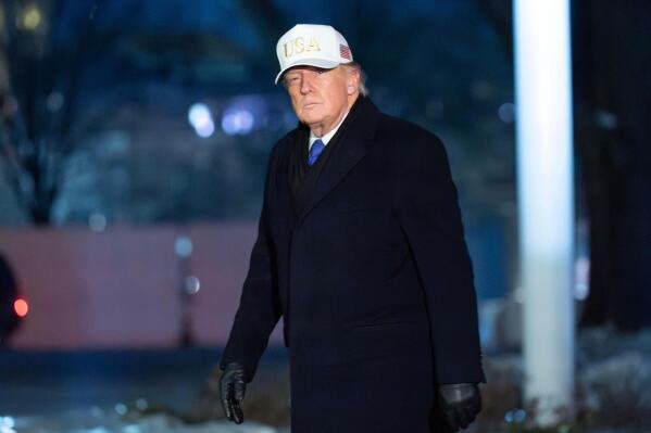 President Donald Trump walks on the South Lawn upon his arrival to the White House, Sunday, Feb. 1, 2026, in Washington. (AP Photo/Jose Luis Magana)