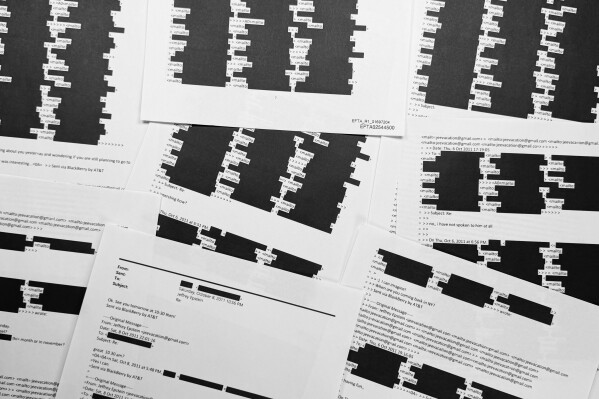 A document with an email chain from Jeffrey Epstein illustrates the amount of redactions of personally identifiable information that the U.S. Department of Justice was required to do before release of Epstein documents, is photographed Sunday, Feb. 1, 2026. (AP Photo/Jon Elswick)