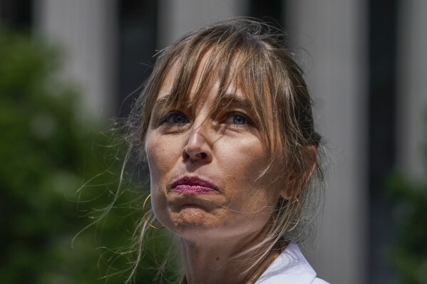 FILE - Annie Farmer, one of the four accusers who testified against Ghislaine Maxwell at trial, speaks to members of the media with her lawyer Sigrid McCawley outside federal court June 28, 2022, in New York. (AP Photo/John Minchillo)