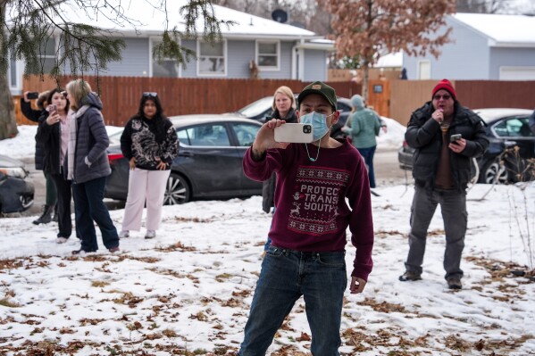 Observers blow their whistles while federal agents conduct immigration enforcement operations, Thursday, Feb. 5, 2026, in Minneapolis. (AP Photo/Ryan Murphy)