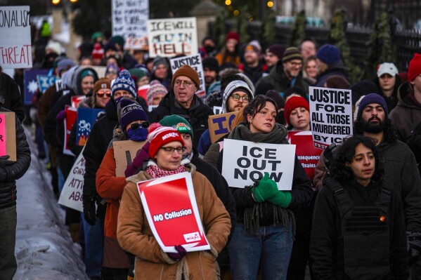 People take part in an anti-ICE protest outside the Governors Residence in St. Paul, Minn., on Friday, Feb. 6, 2026. (AP Photo/Ryan Murphy)
